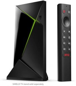 Black NVIDIA Shield TV Pro streaming device with remote control on white background, featuring a sleek triangular design with green LED strip.